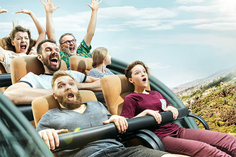 Happy people having good time on a roller coaster