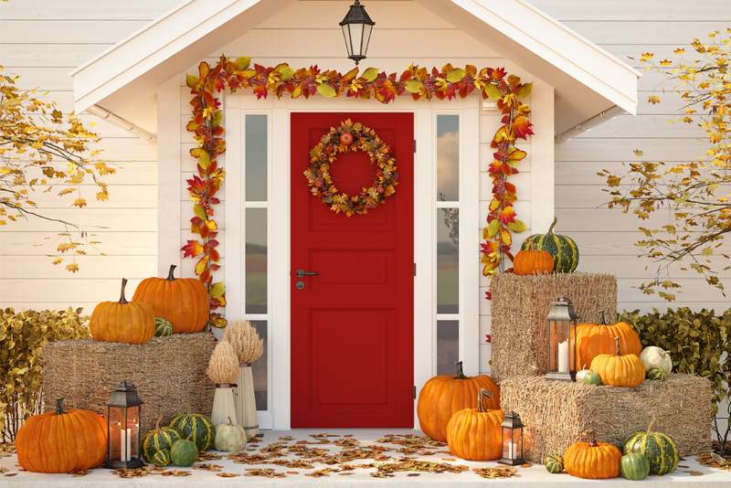 autumn decorated house with pumpkins and hay